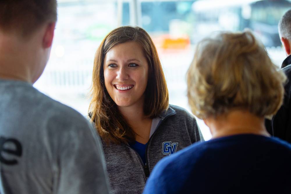 Woman smiling at Comerica Park event under tent